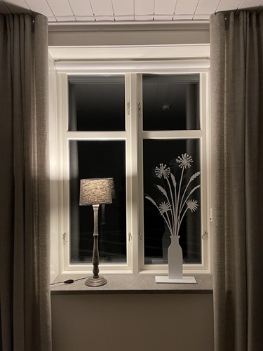 Pampas grass in a window with a lamp